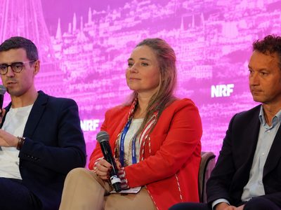 Sebastian Vestergaard of JOE & THE JUICE speaks on an NRF Europe panel in Paris beside Sissi Freeman of Granado and Fabien Stutz of L'Osteria